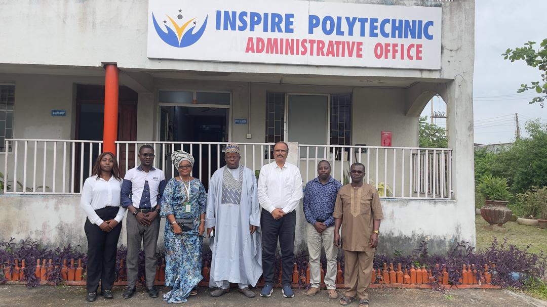 Seven attendees outside the Inspire Polytechnic Administrative Office during the JAMB visit on 7 October 2026.